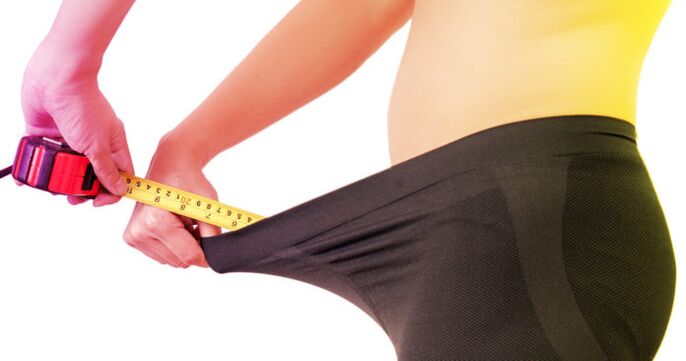 A man measures his penis before it enlarges